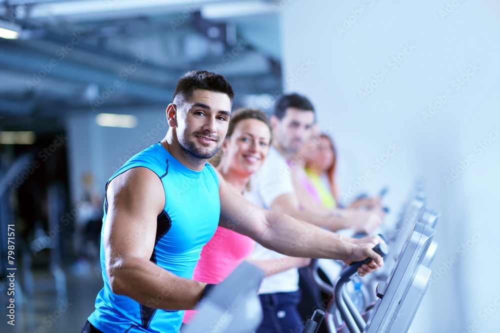 Group of people running on treadmills