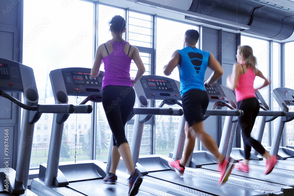 Fototapeta premium Group of people running on treadmills
