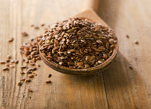 Flax seeds heap on a wooden spoon