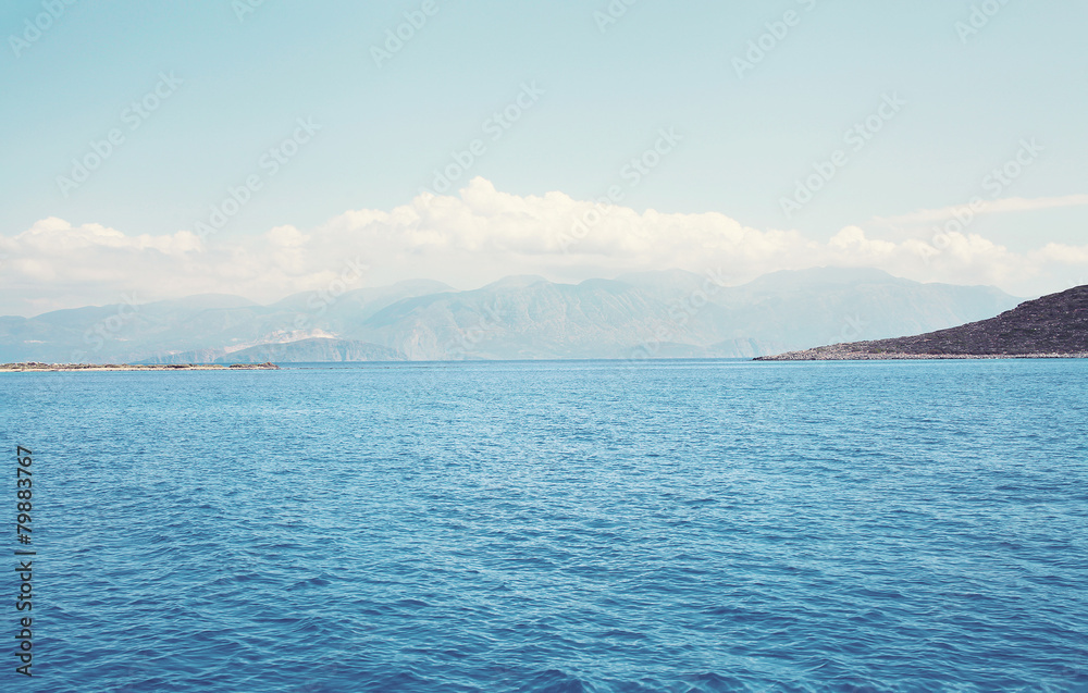 Landscape sea and mountains with clouds in the distance Landscape sea and mountains with clouds in the distance