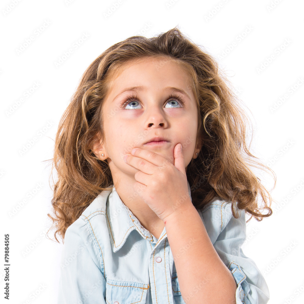 Blonde little girl thinking over white background Blonde little girl thinking over white background