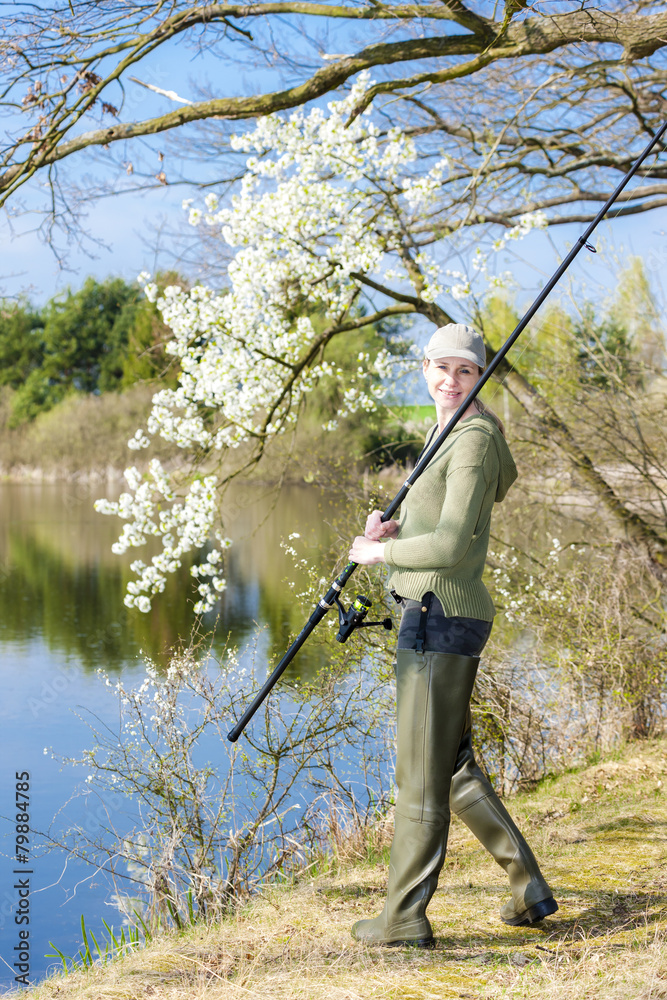 woman fishing at pond in spring woman fishing at pond in spring