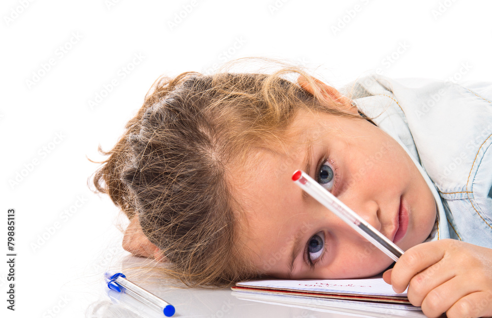 Blonde little girl studing on the floor