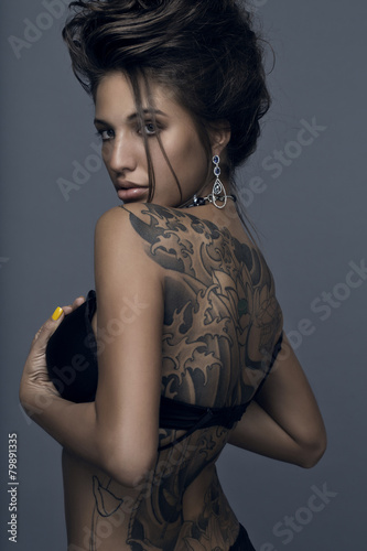 Sensual brunette woman with tattoo
