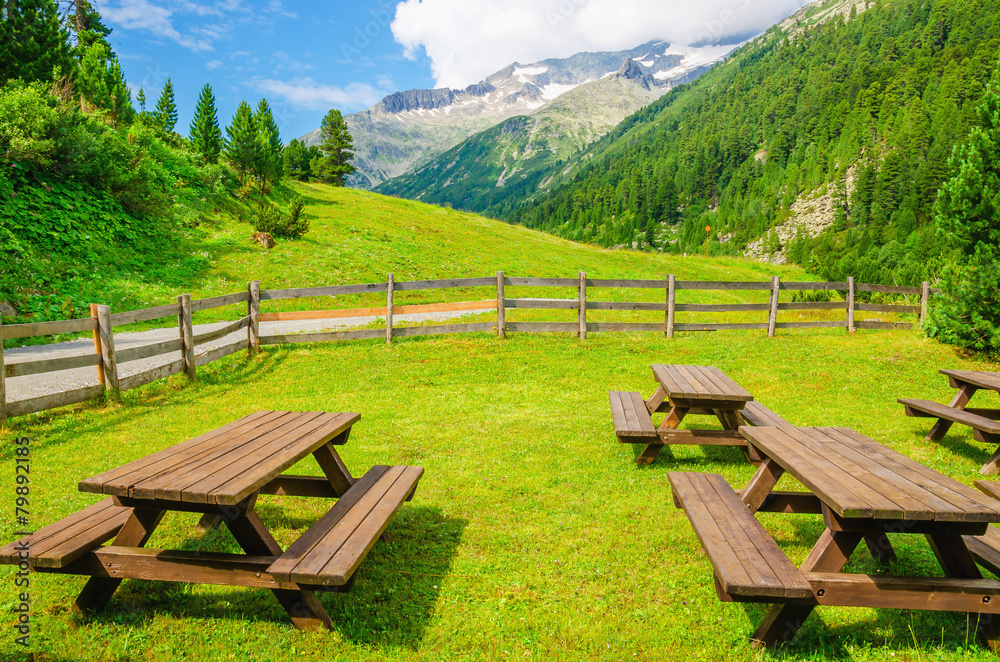 Wooden benches for visitors to picnic, beautiful views of Alps