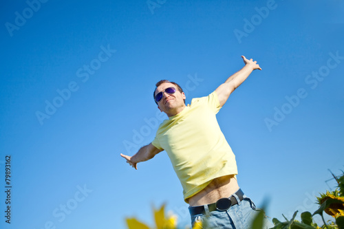 Happy man are jumping in sunflowers