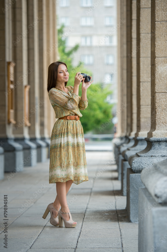 Girl making photo with retro camera