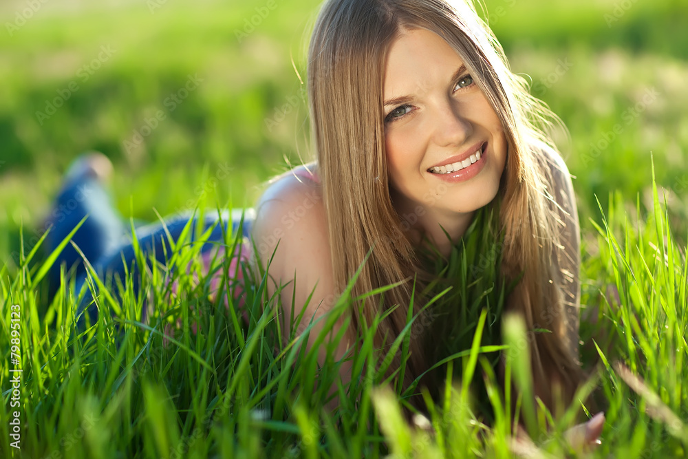 Beautiful woman are relaxing in a spring green field Beautiful woman are relaxing in a spring green field