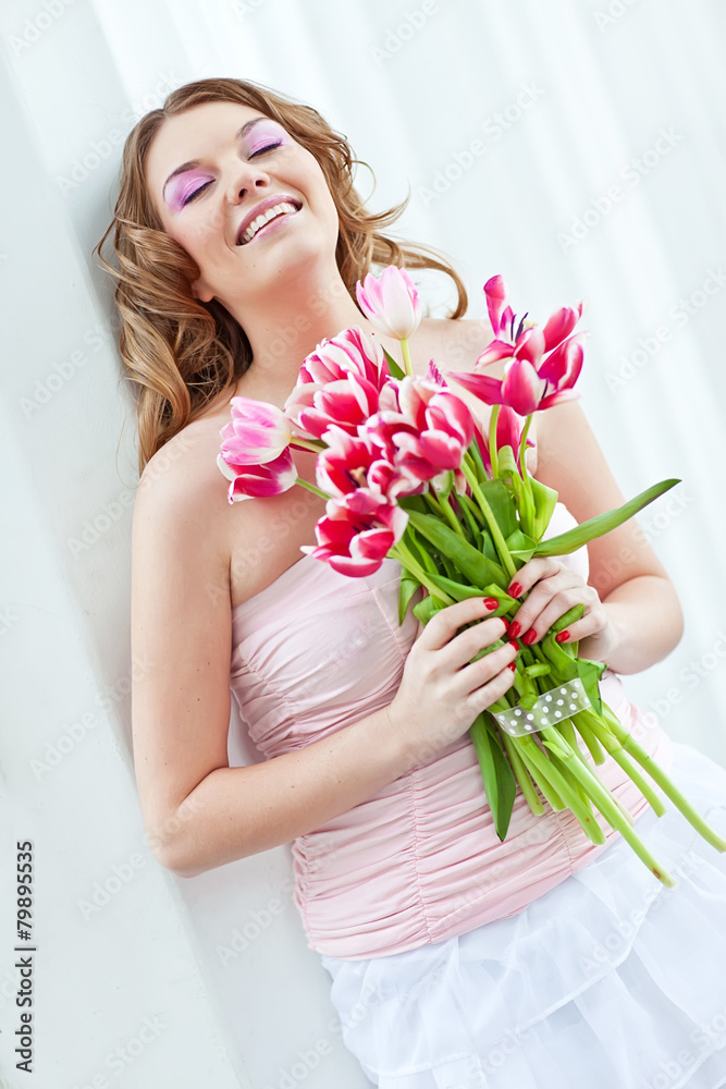 Happy woman with a bouquet of pink tulips