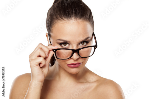 suspicious girl with glasses on a white background