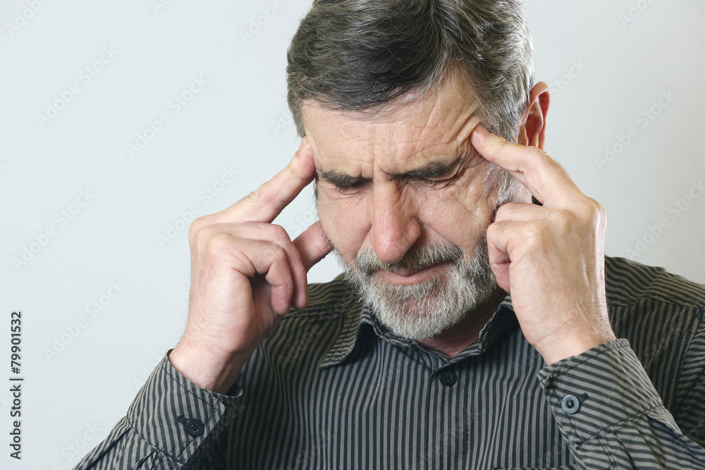 Frustrated senior man holding his head, suffering from headache Frustrated senior man holding his head, suffering from headache