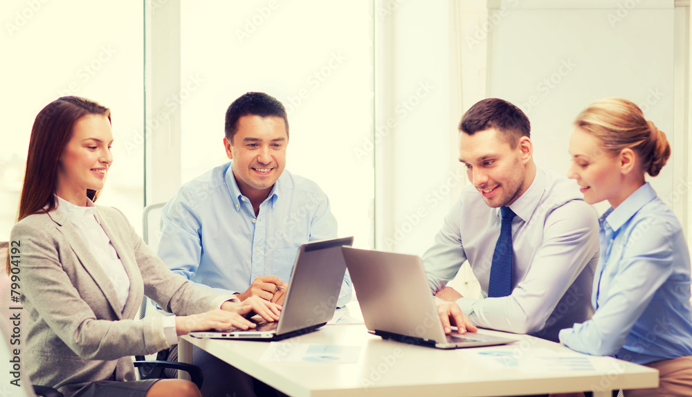 business team working with laptop in office