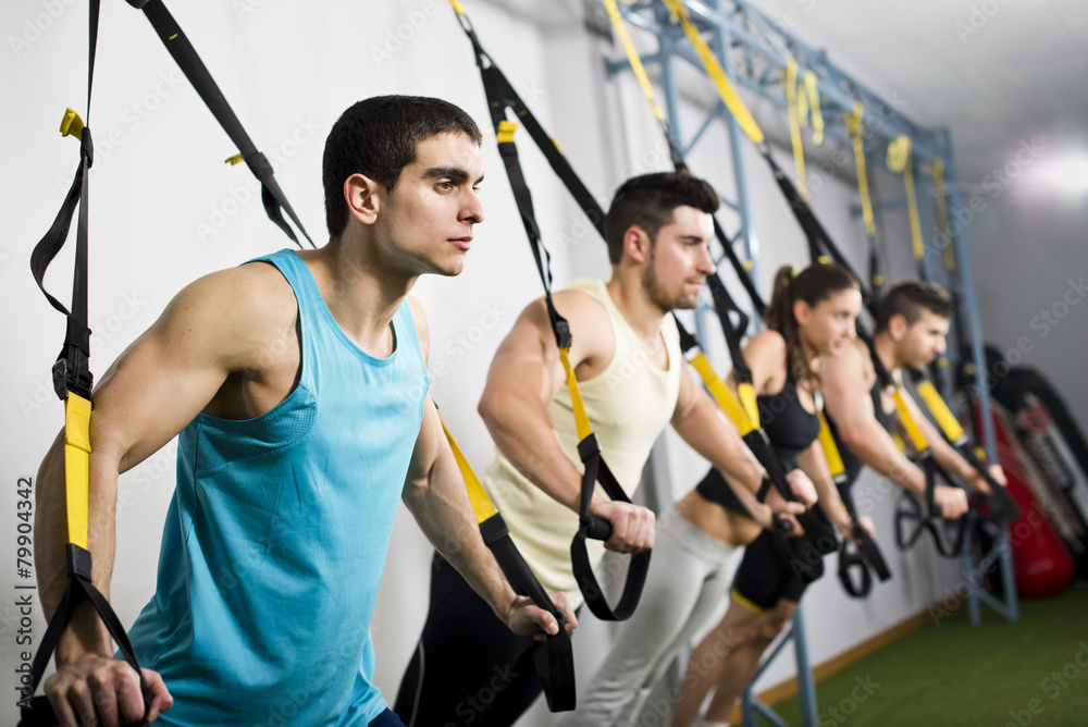 People traiing in elastic trx rope People traiing in elastic trx rope