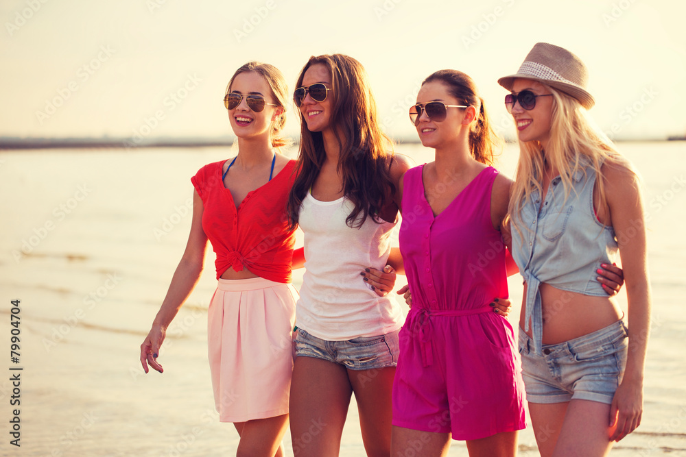 group of smiling women in sunglasses on beach group of smiling women in sunglasses on beach