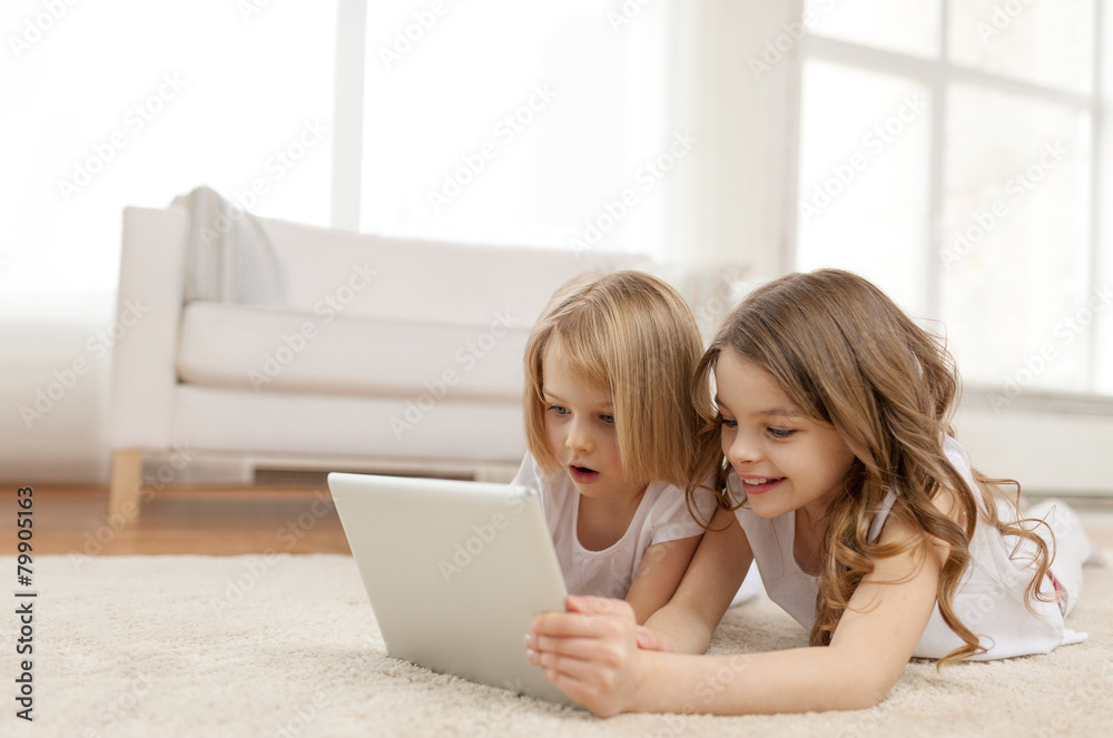two little girls with tablet pc at home two little girls with tablet pc at home