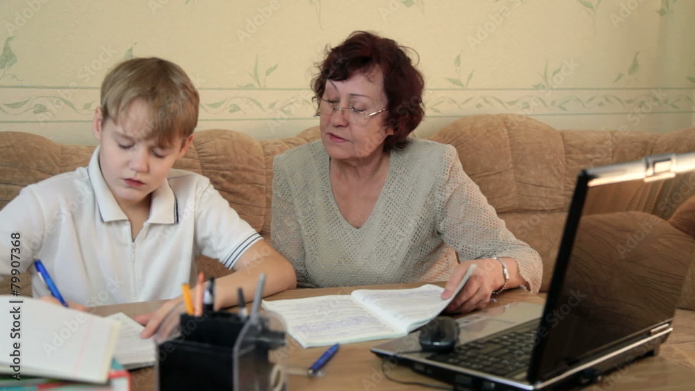 Grandma helping her grandson doing homework Grandma helping her grandson doing homework