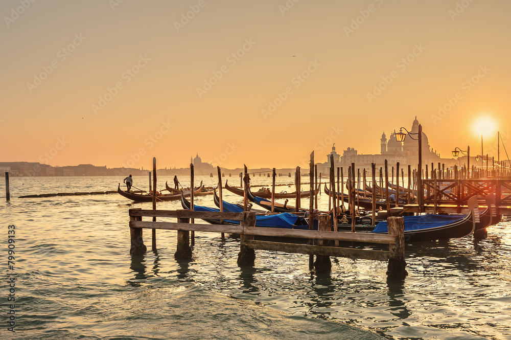 Venetian gondolas on the Grand Canal in a romantic light of suns
