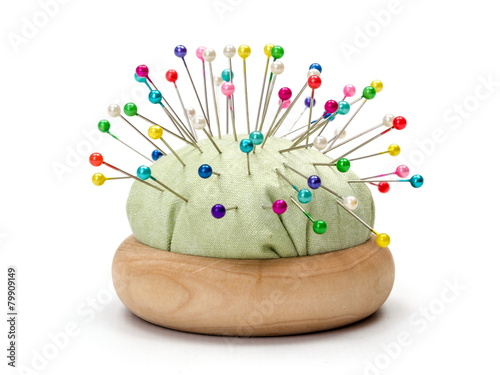 Pin cushion full with colorful pins photo