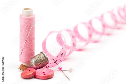 Sewing accessories: thread, needle and thimble photo