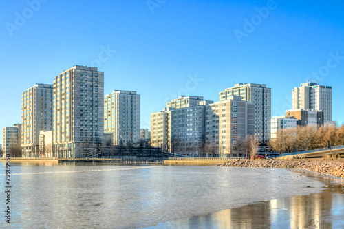 Helsinki city scape reflecting on a frozen ocean bay © Alexander_photo