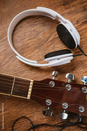 acoustic guitar and headphone on fabric sofa photo