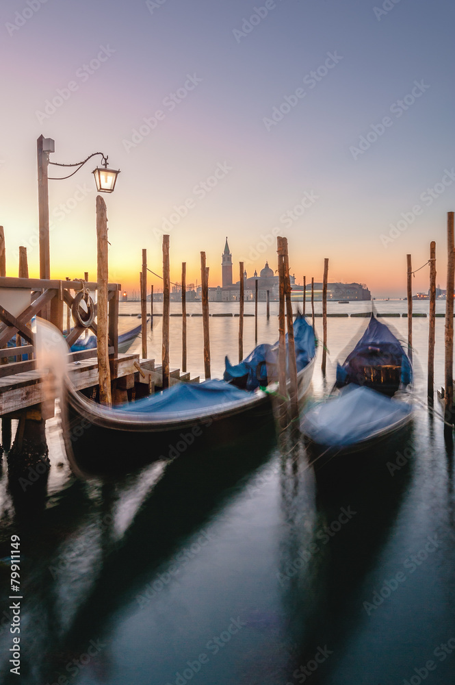 Gondolas docked to the poles on the Grand Canal in Venice.