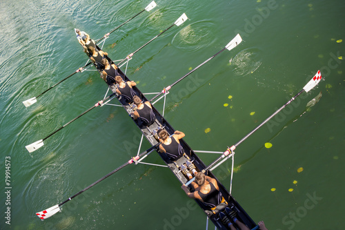 Boat coxed eight Rowers rowing on the tranquil lake photo