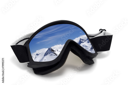 Ski goggles with reflection of mountains at sunny day