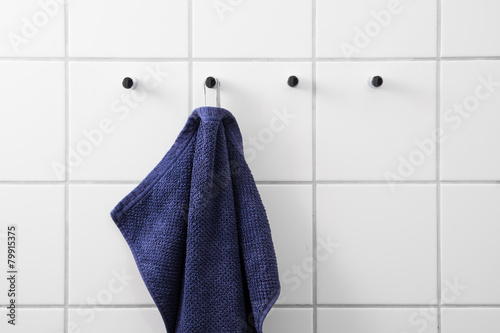 Blue towel white tiles