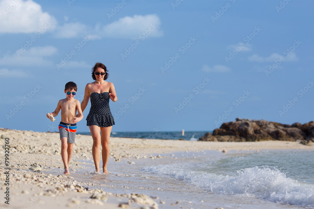 Young mother and son playing on the beach Young mother and son playing on the beach