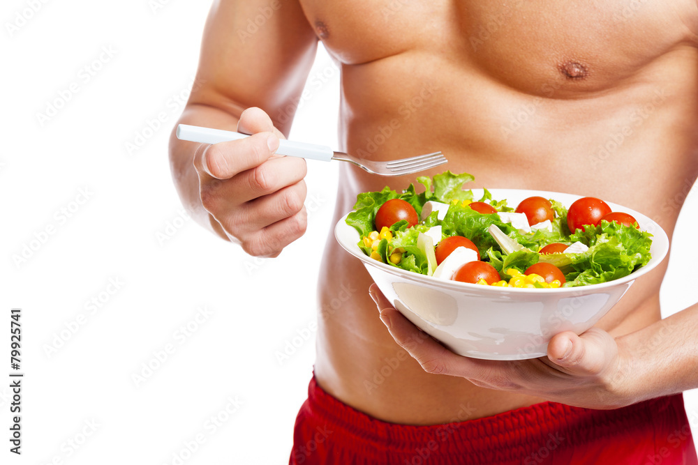 Fit man holding a bowl of fresh salad on white background Fit man holding a bowl of fresh salad on white background