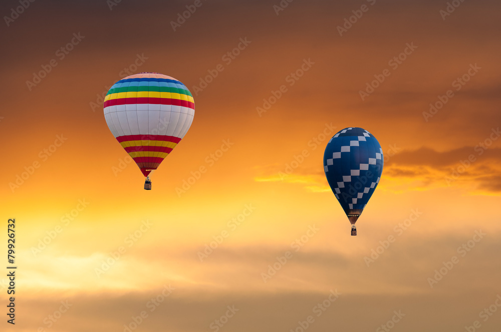 Fototapeta premium Two Hot Air Balloons in Flight on sunset sky background