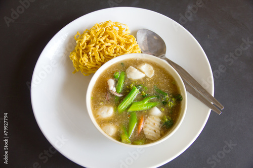 Fried noodle with pork and kale soaked in gravy - Stock Image