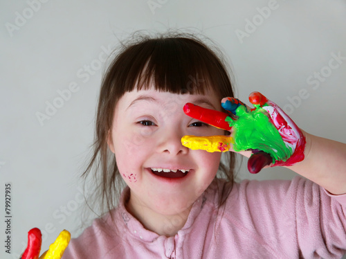 Cute little girl with painted hands.