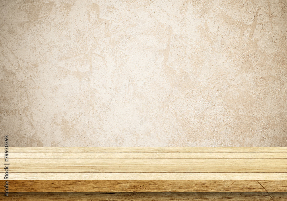 Empty wooden table over cement wall Empty wooden table over cement wall