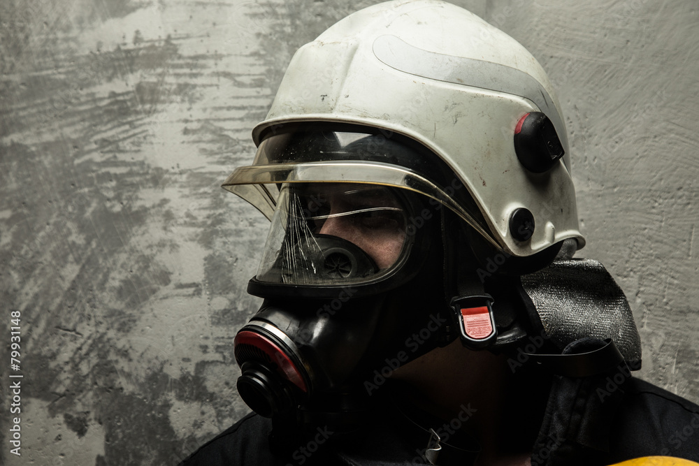 Fototapeta premium Firefighter in helmet and oxygen mask