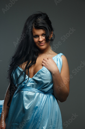 Fotografie Portrait of dark haired woman in blue dress