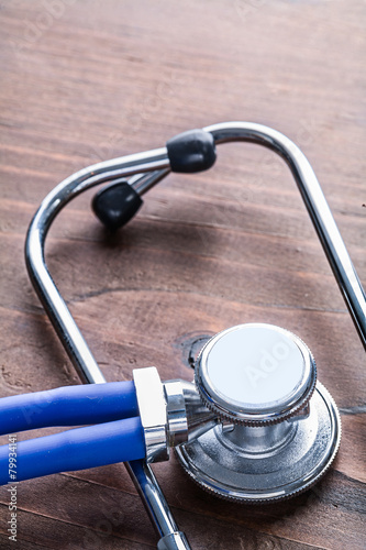 medical stethoscope very close up view on vintage wooden board