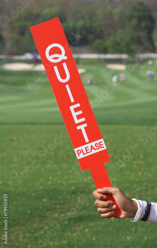 Quiet please sign was shown by staff in golf tournament.