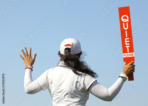 The lady volunteer shows the quite please sign in golf tournamen photo