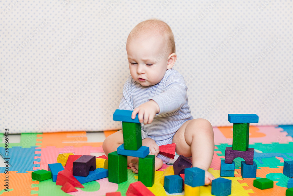 Cute little baby playing with colorful toys Cute little baby playing with colorful toys