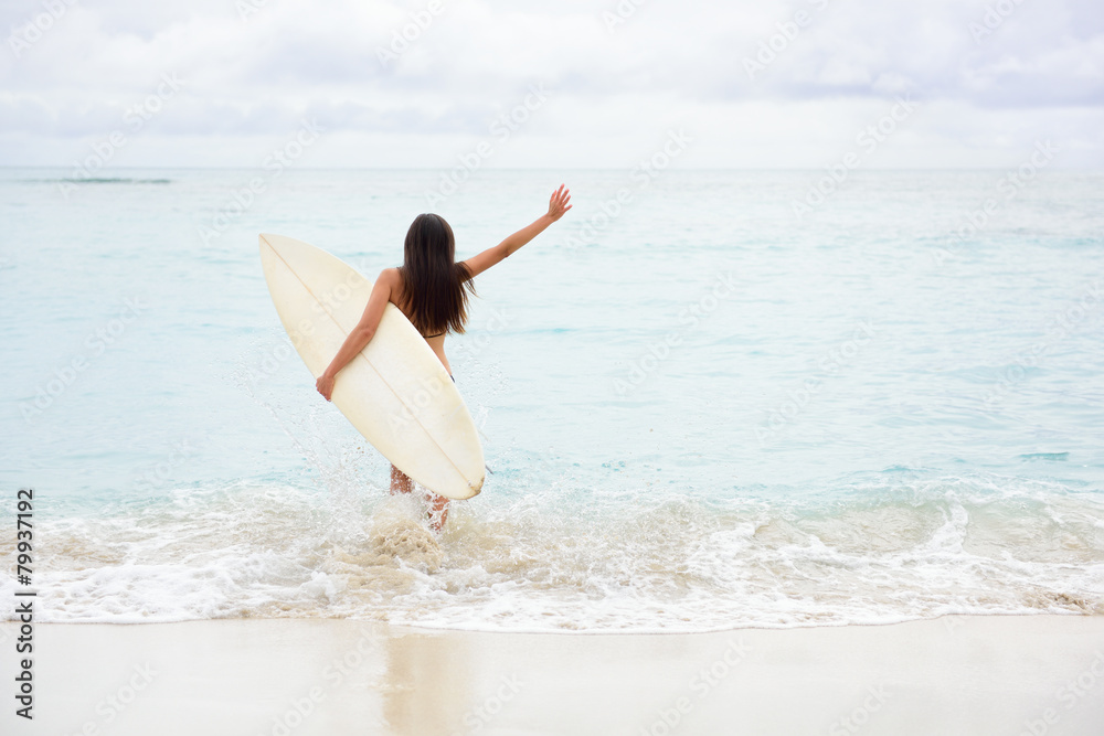 Surfing girl happy excited going surfing at beach Surfing girl happy excited going surfing at beach