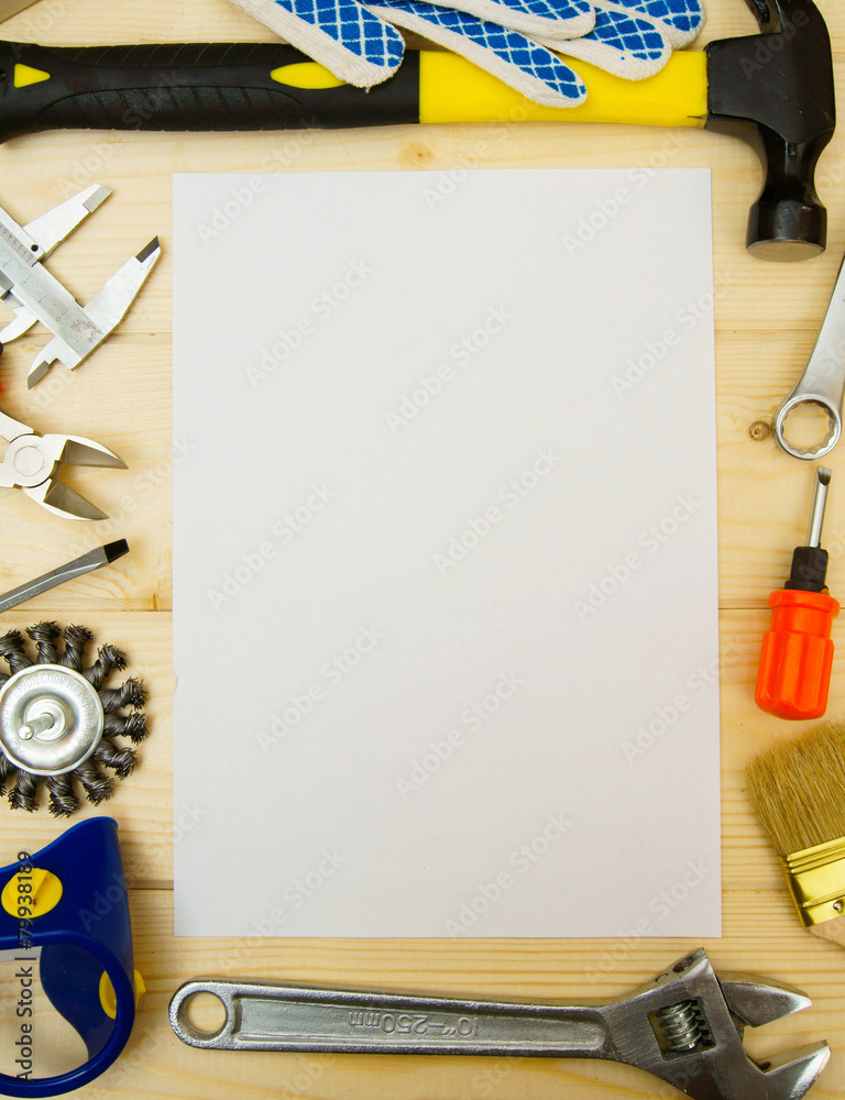 Paper for notes and set of working tools on wooden background. Paper for notes and set of working tools on wooden background.