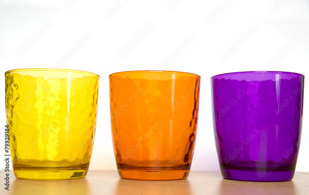 colorful glass cups on a white background colorful glass cups on a white background