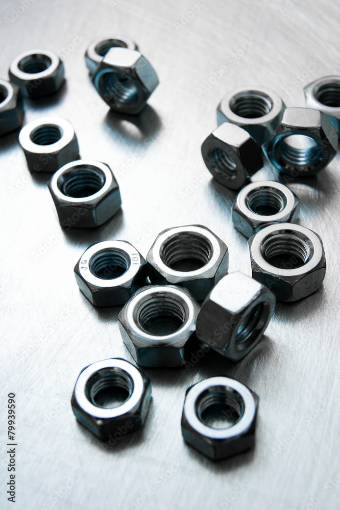 Nuts on scratched metal background.
