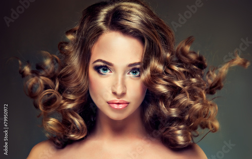 Beautiful model brunette with long curled hair #79950972
