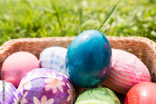 easter eggs in basket on grass