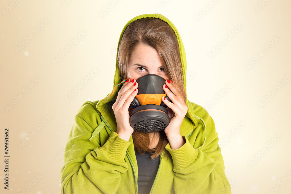 Obraz premium Girl with gas mask over white background