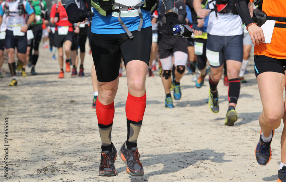 runners racing on the road while riding in a race runners racing on the road while riding in a race