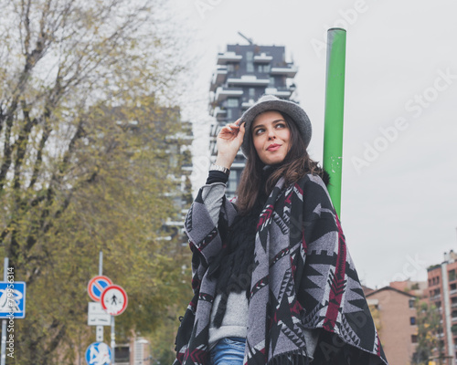 Beautiful young brunette posing in the city streets